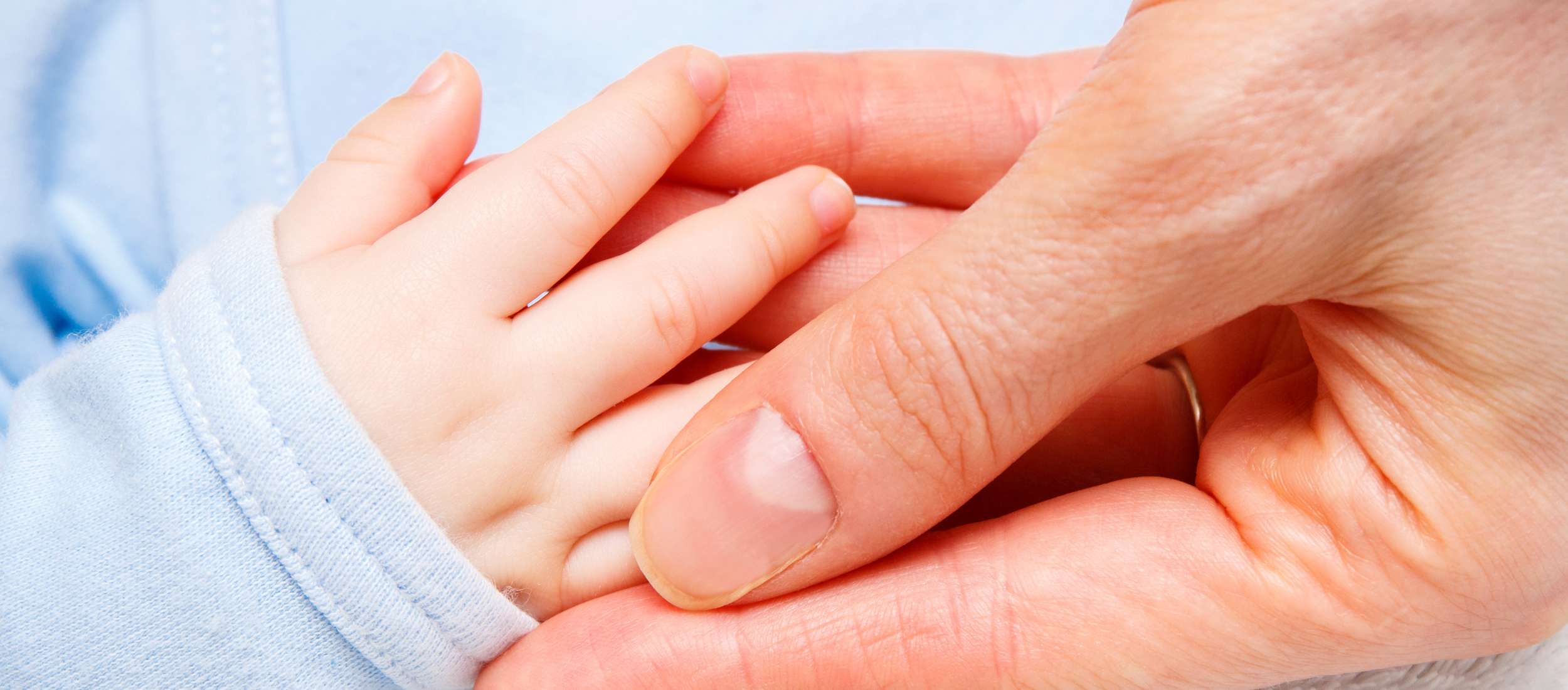 hand of newborn baby in hand of mother